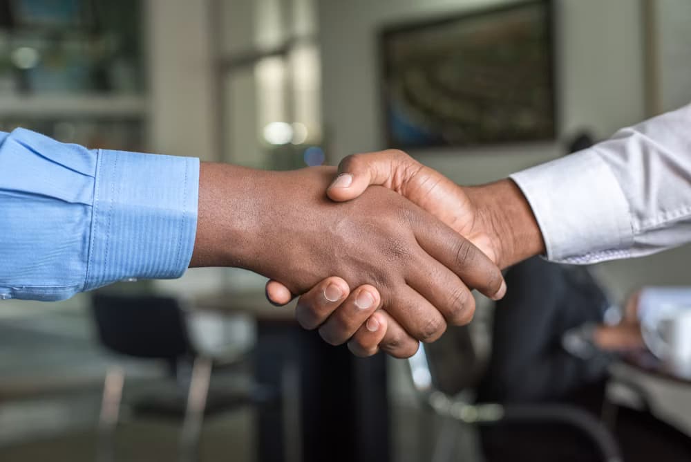 Two professionals shaking hands in an office