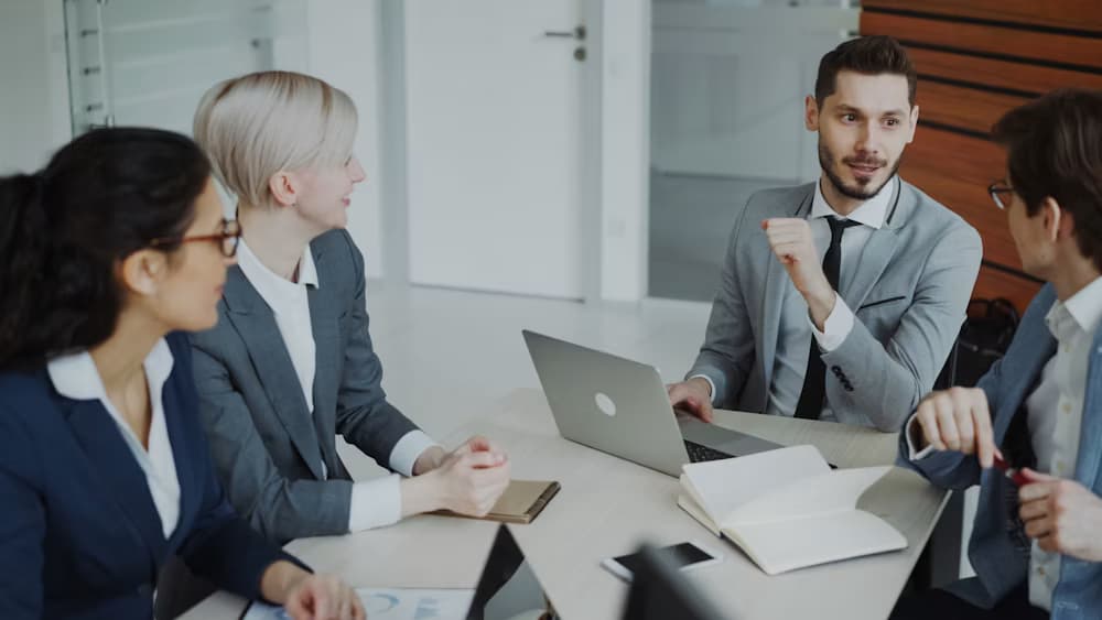 Executives in a business meeting reviewing reports